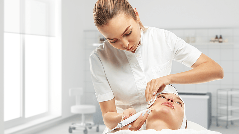 Esthetician providing services to patient.