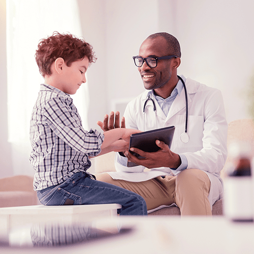 Young male Physician with patient with stethoscope in medical office.