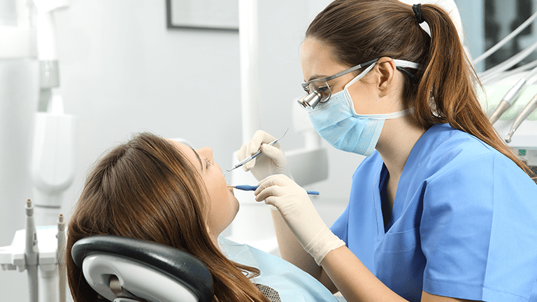 Woman is at dentist's office for appointment.